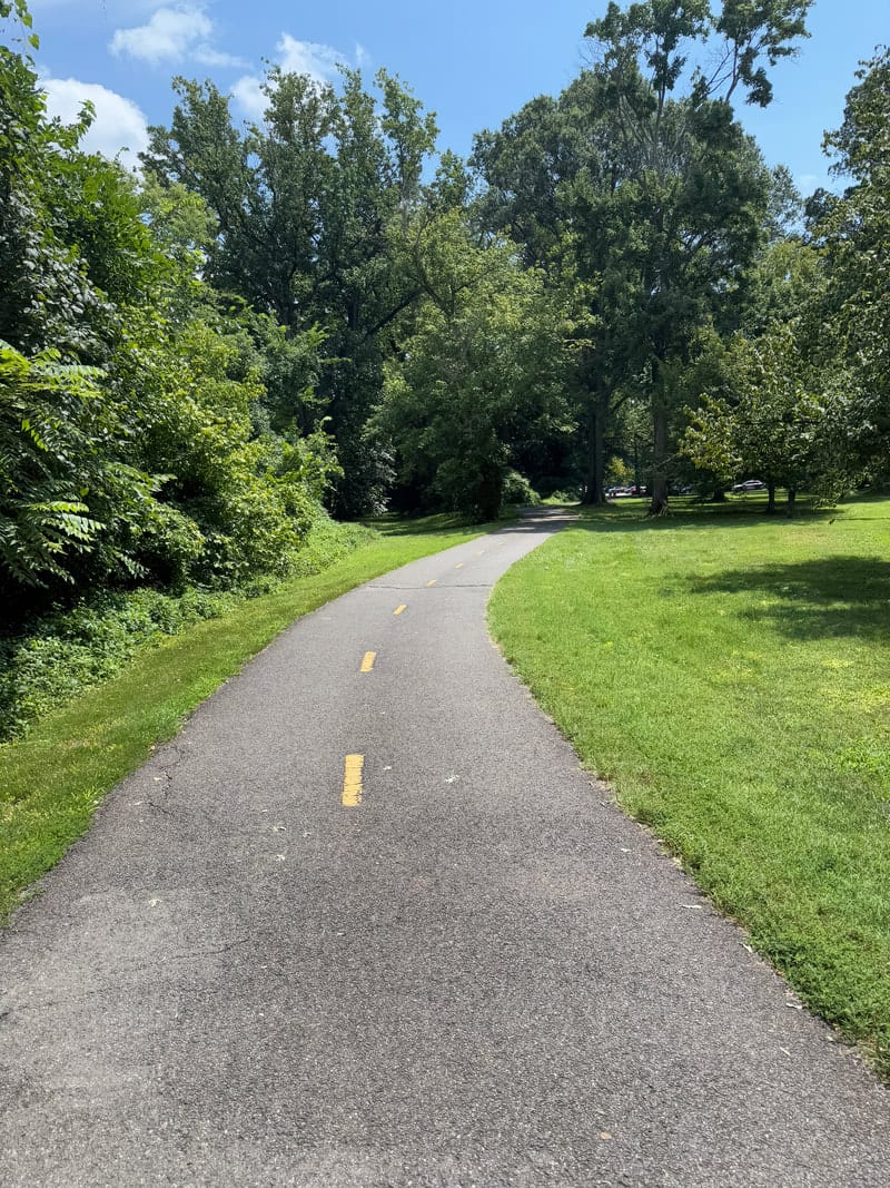 An unmarked accessible trail at Belle Haven Park with no shade or seating