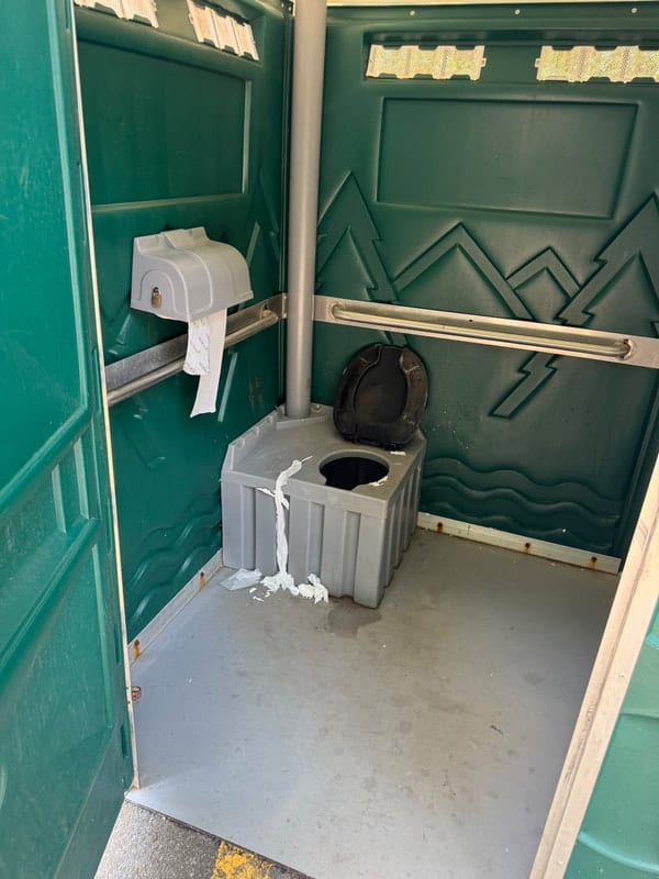 An accessible porta-potty in the parking lot at Huntley Meadows Park