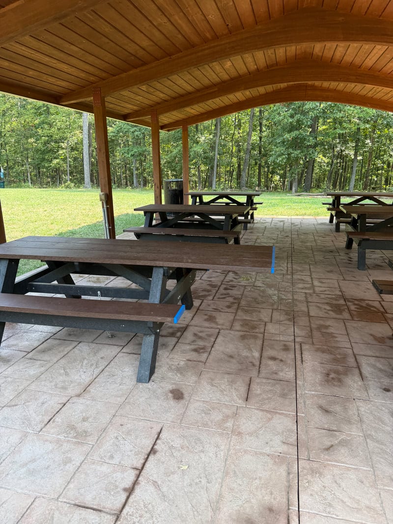 An accessible grill and trash can at Potomac Crossing Park's picnic structure