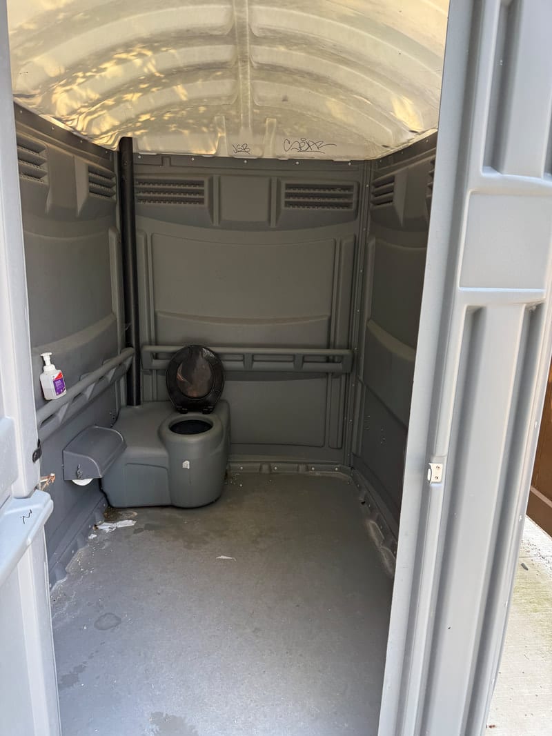 A clean, large accessible porta-potty near the shelter at Potomac Crossing Park