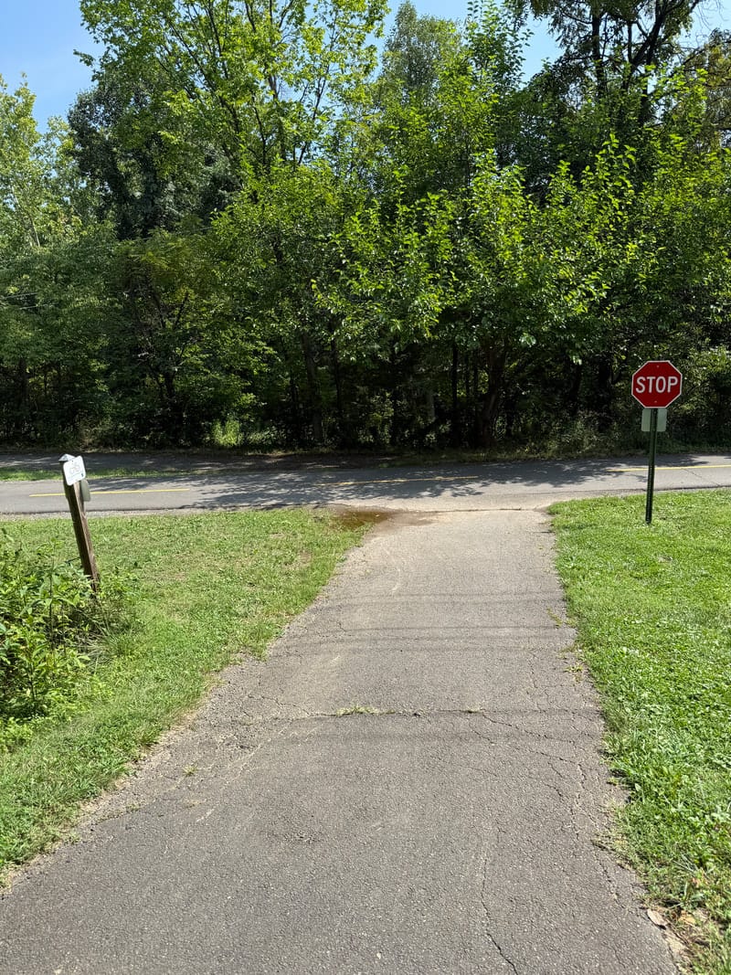 A trail descending from the playground to the main bike trail at Tuscarora Park