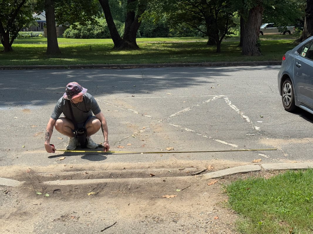 A park amenity being measured during an accessibility site survey
